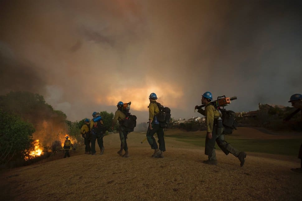 Firefighters of the Texas Canyon Hotshot crew fight the Sand Fire at a residential golf course on July 23 2016 near Santa Clarita, California. Fueled by temperatures reaching about 108 degrees fahrenheit, the wildfire began yesterday has grown to 11,000 acres. / AFP / DAVID MCNEW (Photo credit should read DAVID MCNEW/AFP/Getty Images)