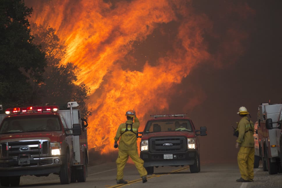 SANTA CLARITA, CA - JULY 24: Firefighters are forced to retreat as flame close in on them in Placerita Canyon at the Sand Fire on July 24, 2016 in Santa Clarita, California. Triple-digit temperatures and dry conditions are fueling the wildfire, which has burned across at least 22,000 acres so far and is only 10% contained. (Photo by David McNew/Getty Images)